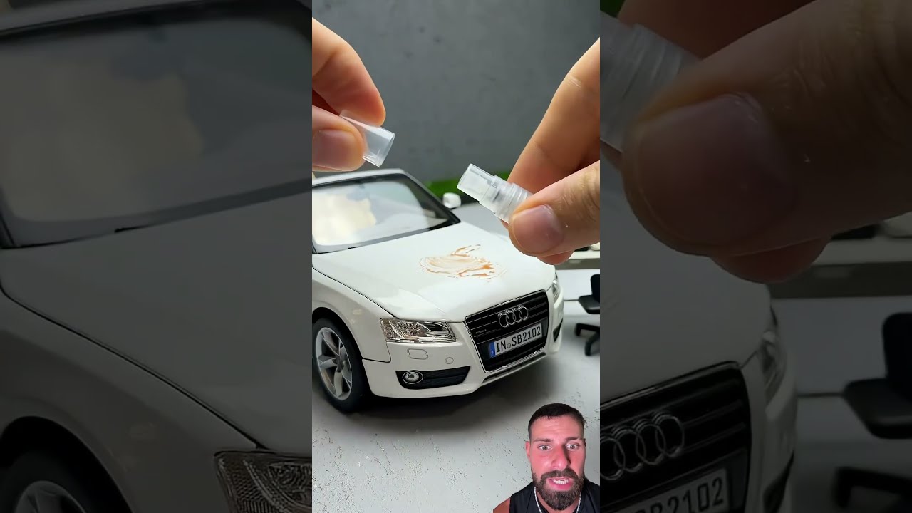 Alguien pinta y limpia un coche de juguete